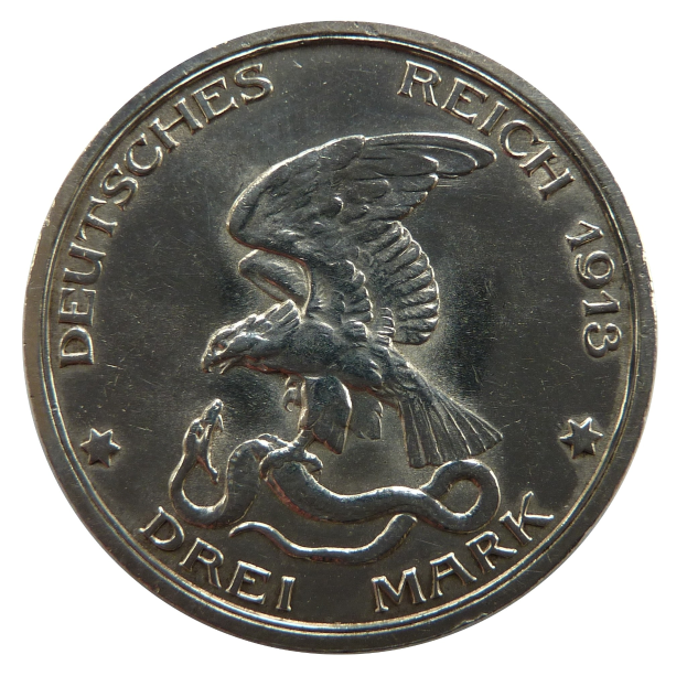 Eine Silbermünze mit der Aufschrift "Deutsches Reich" mit einem Adler mit gespreizten Flügeln, der eine Schlange packt.