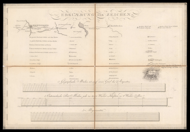 Ein aufgeschlagenes Buch mit schwarzem Einband, das eine Deutschlandkarte und Text sowie eine Zeichnung zeigt.