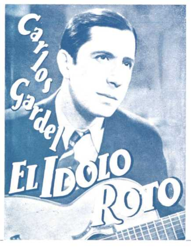 Plakat von El Idolo Roro, einem spanischen S├Ąnger-Schreiber, der eine Gitarre h├Ąlt, ein wei├čes Hemd und einen schwarzen Anzug tr├Ągt, mit zur├╝ckgek├Ąmmten Haaren und einem ernsten Gesichtsausdruck, vor einem hellblauen Hintergrund mit fetter schwarzer Schrift.